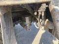 A close-up of the underside of a 2014 International 7400 showing a mounted component and various mechanical parts connected by hoses and wires