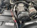 An engine compartment of a 2003 Ford F-450 SD showcasing various components including the alternator belts wires and hoses