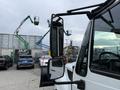 A 2012 International TerraStar truck with a prominent side mirror showcasing its angular design and sturdy build