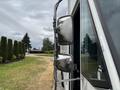 A close-up view of the side mirror of a 2018 Ford Econoline showing its reflective surface and sturdy design