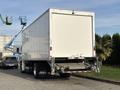 A 2022 Lion Lion6 electric truck with a large white cargo box and a rear loading ramp visible