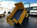 A 2013 Yanmar C12R-B tracked dump truck with an open bed tilted at an angle showcasing its interior features and yellow exterior