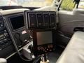 A control panel with buttons for liquid, spread, dump, spread off, plow, and system on/off in a 2012 International TerraStar truck interior
