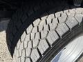 Close-up of a tread pattern on a worn tire of a 2019 Ford F-550 showing deep grooves and uneven wear