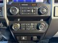 A close-up view of the control panel in a 2020 Ford F-350 featuring audio controls climate settings and air conditioning buttons