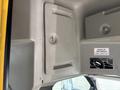 Interior view of a 2018 Chevrolet Express showing ceiling features including storage compartments and a height warning sign
