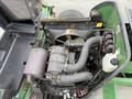 Close-up of the engine components of a 2009 John Deere 2653B Precision Diesel Mower featuring hoses filters and an air intake system