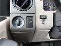 Interior dashboard controls of a 2008 Ford F-450 SD including switch for headlights and additional function buttons