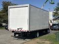 A 2018 Hino 195 box truck with a plain white exterior and no visible branding parked at an angle with an empty cargo area visible