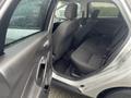 2018 Ford Focus showing the rear interior with black cloth seats and a view of the front passenger area