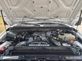 Engine compartment of a 2009 Ford F-450 Super Duty featuring a Power Stroke V8 Turbo Diesel engine with various components and hoses visible