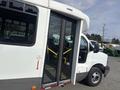 2018 Chevrolet Express with a kneeling feature and large side doors open for accessibility purposes