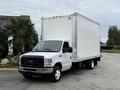 A 2019 Ford Econoline truck with a white box cargo area and a black grille parked at an angle