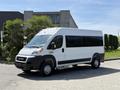 A white 2021 RAM Promaster van parked with large windows and a sleek design featuring black accents on the lower side and wheels