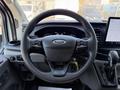 Interior view of a 2022 Ford Transit showing the steering wheel with Ford logo and control buttons along with a touchscreen display on the dashboard