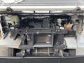 A 2018 Ford Econoline engine compartment featuring the engine assembly cooling system and various mechanical parts visible