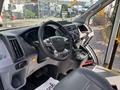 Interior view of a 2018 Ford Transit-350 showcasing the steering wheel dashboard controls and seats