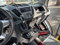 Interior of a 2018 Ford Transit-350 showing the driver's seat gear shift dashboard controls and multimedia display with various switches and buttons