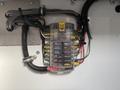 A 2012 Ford Econoline E-450 electrical panel with labeled switches and various colored wires connected to it