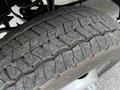 Close-up of a worn tire on a 2016 Ford F-550 showing visible tread wear and cracks on the rubber surface