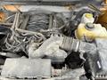 A 2014 Ford F-150 engine with various components including a large air intake and numerous hoses showing signs of dirt and wear