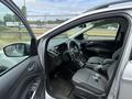 A 2015 Ford Escape with an open driver's door showcasing the interior including steering wheel console and seating