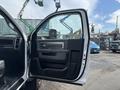 A 2016 RAM 5500 with its front door open showing the interior door panel and controls