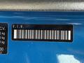 A blue 2021 Kia Forte VIN label displaying a barcode and vehicle specifications