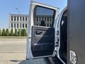 A white 2005 GMC C7500 Topkick truck with an open driver's door revealing the interior door panel and black seating area