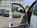 A white 2008 Ford F-250 SD with the driver's side door open revealing the interior features and beige door panel