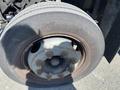 Close-up of a 1996 GMC Top Kick truck wheel showcasing the tire and rim with visible wear and multiple lug nuts securing the wheel