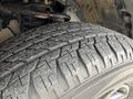 Close-up of a tire from a 2021 Toyota 4Runner showcasing the tread patterns and texture