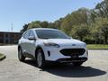 A white 2020 Ford Escape parked with a sleek design featuring curved headlights a wide grille and modern alloy wheels