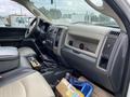 Interior of a 2011 Dodge Ram 5500 featuring a black and beige seating arrangement with a dashboard displaying controls and storage compartments