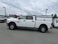 A white 2015 RAM 2500 pickup truck with a silver truck bed cover and chrome wheels is displayed in the foreground