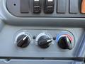 Dashboard controls of a 2013 International CE300 featuring knobs for air circulation heat and temperature settings