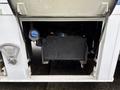 A 2011 Ford F-650 with an open battery compartment revealing the battery and associated components inside