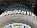 Close-up of a tire from a 2011 Dodge Ram 5500 showcasing its tread pattern and shiny wheel rim