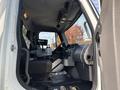 Interior view of a 2013 Freightliner 114SD truck showing the driver's seat dashboard and controls