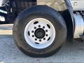 A close-up of a white tire from a 2013 International 7500 showing the rim with multiple lug nut holes and the Goodyear tire brand name on the sidewall