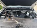 A 2017 Chevrolet Silverado 1500 engine bay showing the V8 engine components air intake and battery with various hoses and wires