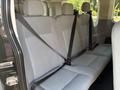 Interior seating of a 2016 Ford Transit 150 with three gray fabric seats and seat belts visible in the foreground