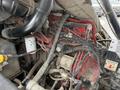 Close-up of a 2012 Global M4 engine showing various connected hoses wires and components