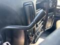 Close-up of a black manual window crank handle inside a 2005 GMC C7500 Topkick truck's cabin