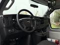 Interior of a 2019 Chevrolet Express featuring a steering wheel dashboard controls and various knobs and buttons