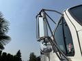 A close-up of the mirror assembly on a 2006 Sterling Acterra truck featuring a rectangular mirror and round side mirror attached to a metallic frame