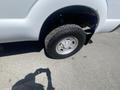A close-up of the front wheel of a 2016 Ford F-350 SD showing the tire and silver alloy rim