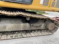 Close-up view of the tracks and undercarriage of a 2018 John Deere 350 machinery showing detailed metal components and worn surfaces