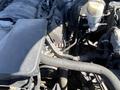 Close-up view of the engine compartment of a 2014 GMC Sierra 1500 showing various components including hoses and a reservoir tank