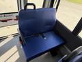 A blue padded seat in a 2020 Chevrolet Express with a seatbelt and a handle on the back